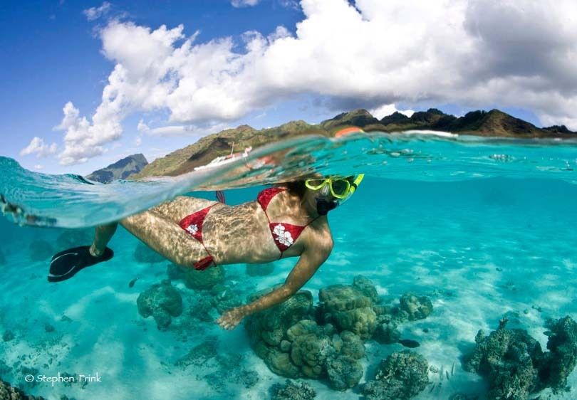 Over/Under of Female Snorkeler, Tahiti