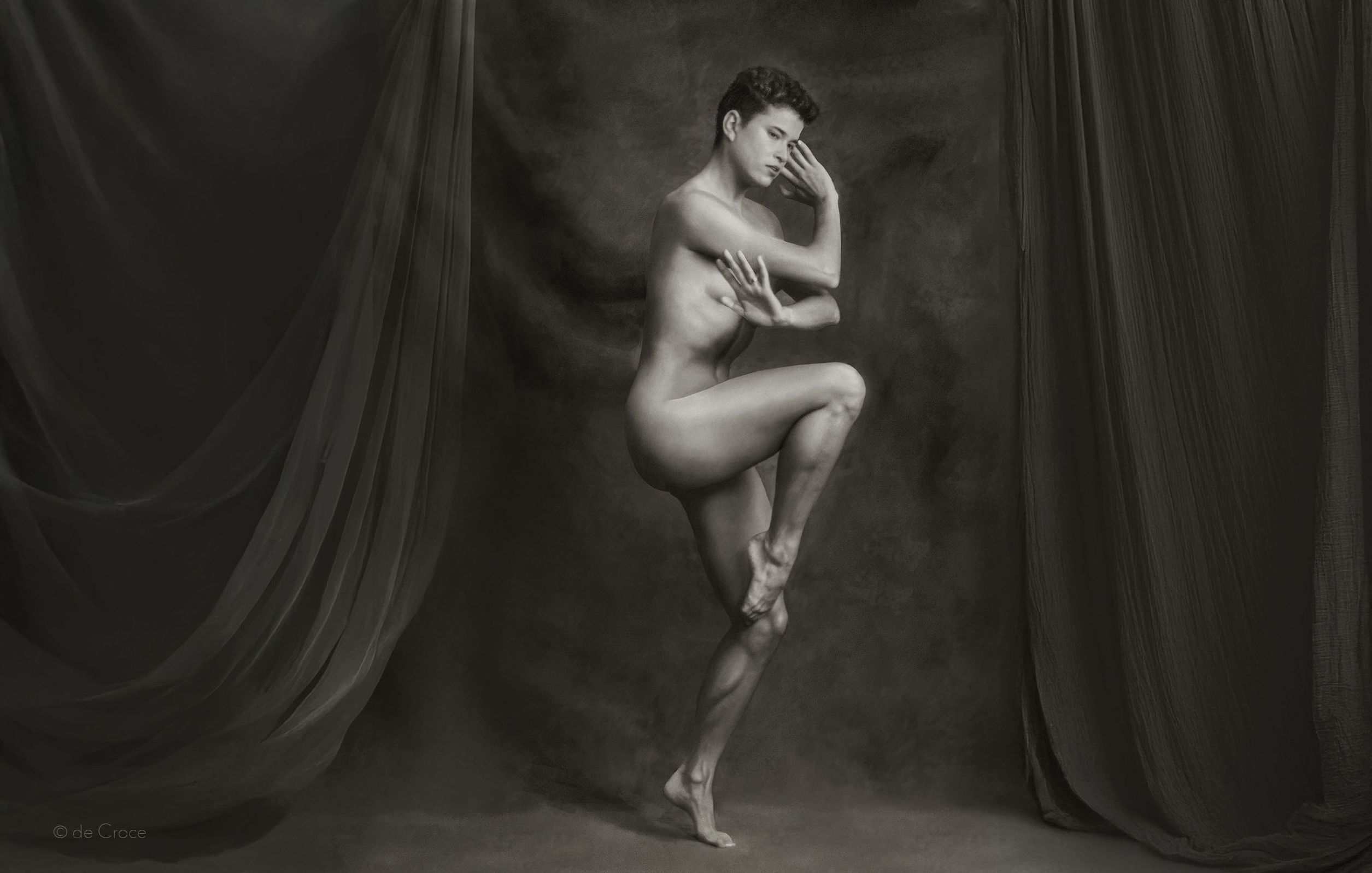 Black and white female ballet dancer in riveting pose shot in studio by commercial photographer, deCroce. Dancer In Studio