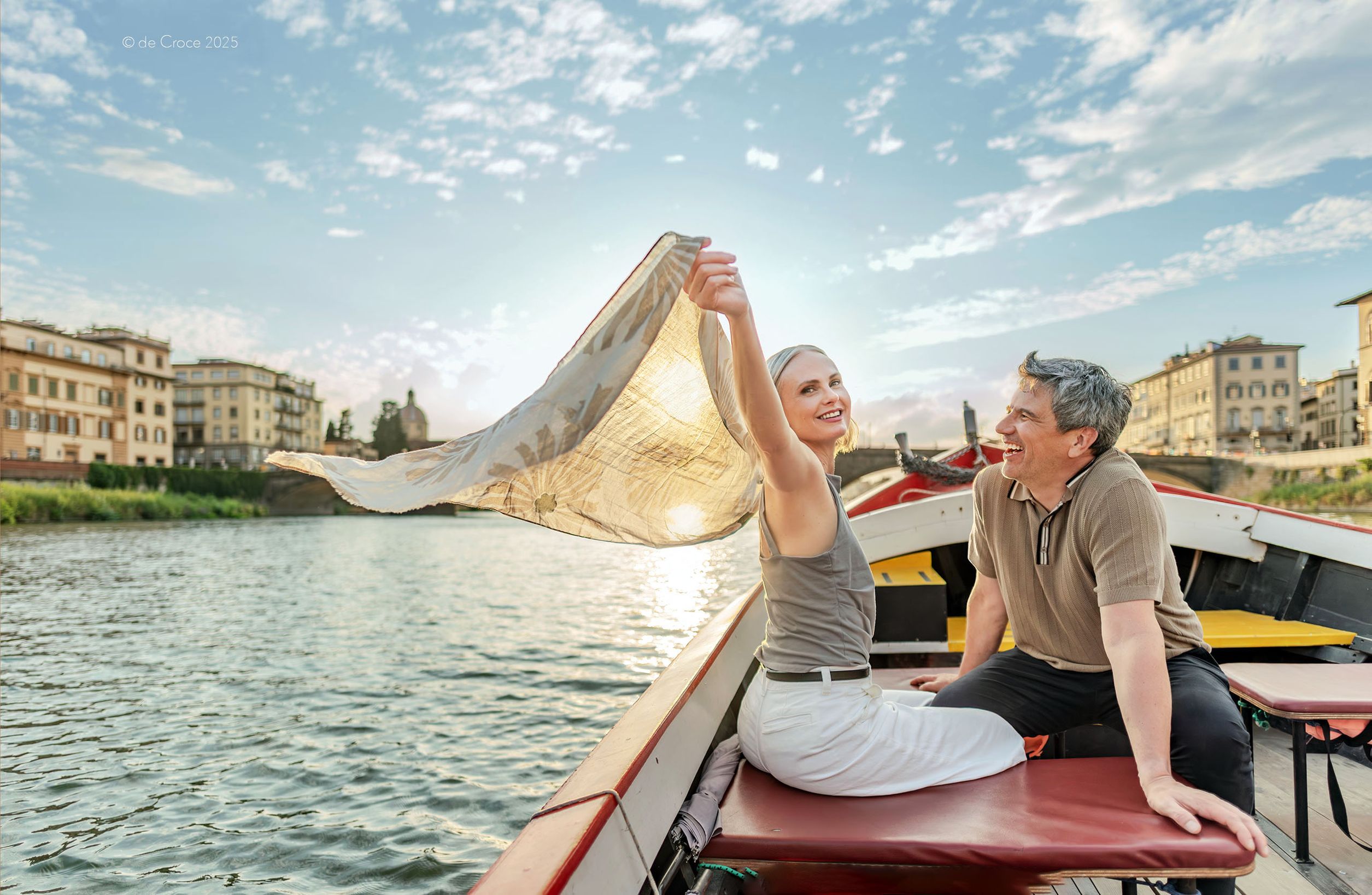 Shot for international travel company (Globus Adventures) by Commercial & advertising photographer DeCroce, the scene features two actors in boat on Arno river under backlit setting sun. Commercial Advertising Photography - Travel Adventure Advertisement - CLIENT_Globus Adventures