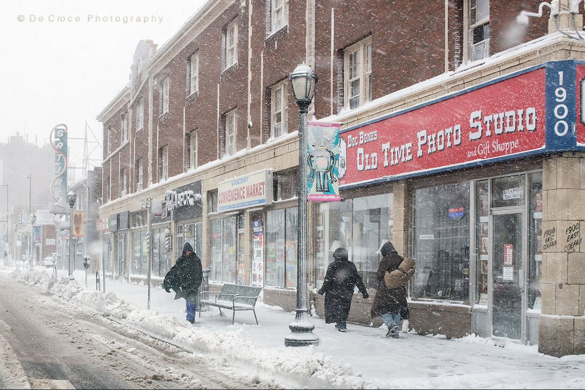 Reportage photography depicting heavy snow on Colfax Avenue as man waits for bus. Cyclone Bomb Colfax