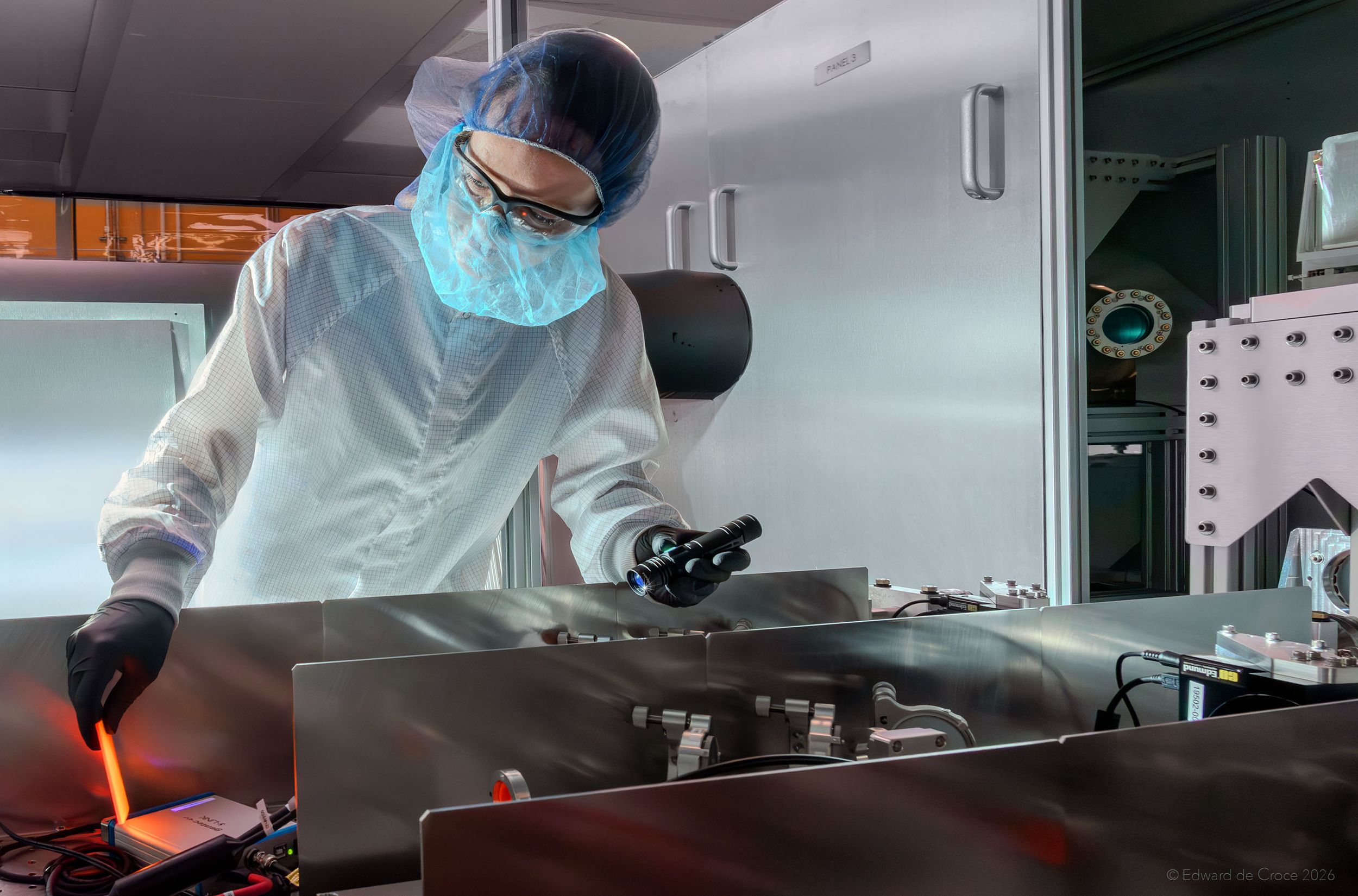 This image depicts an engineer testing laser functionality for breakthrough nuclear fusion energy technology. While on assignment for Xcimer Energy Company, Denver advertising & commercial photographer deCroce crafted authentic science research and industrial imagery. Denver Commercial Photographer Illustrates Research Science Lab