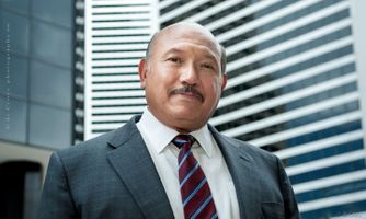 This business headshot portrait with Denver cityscape background of Hispanic business leader was done in Colorado for WPX Energy. Make up by Suzanne Blons. Hispanic Leader Business Photography