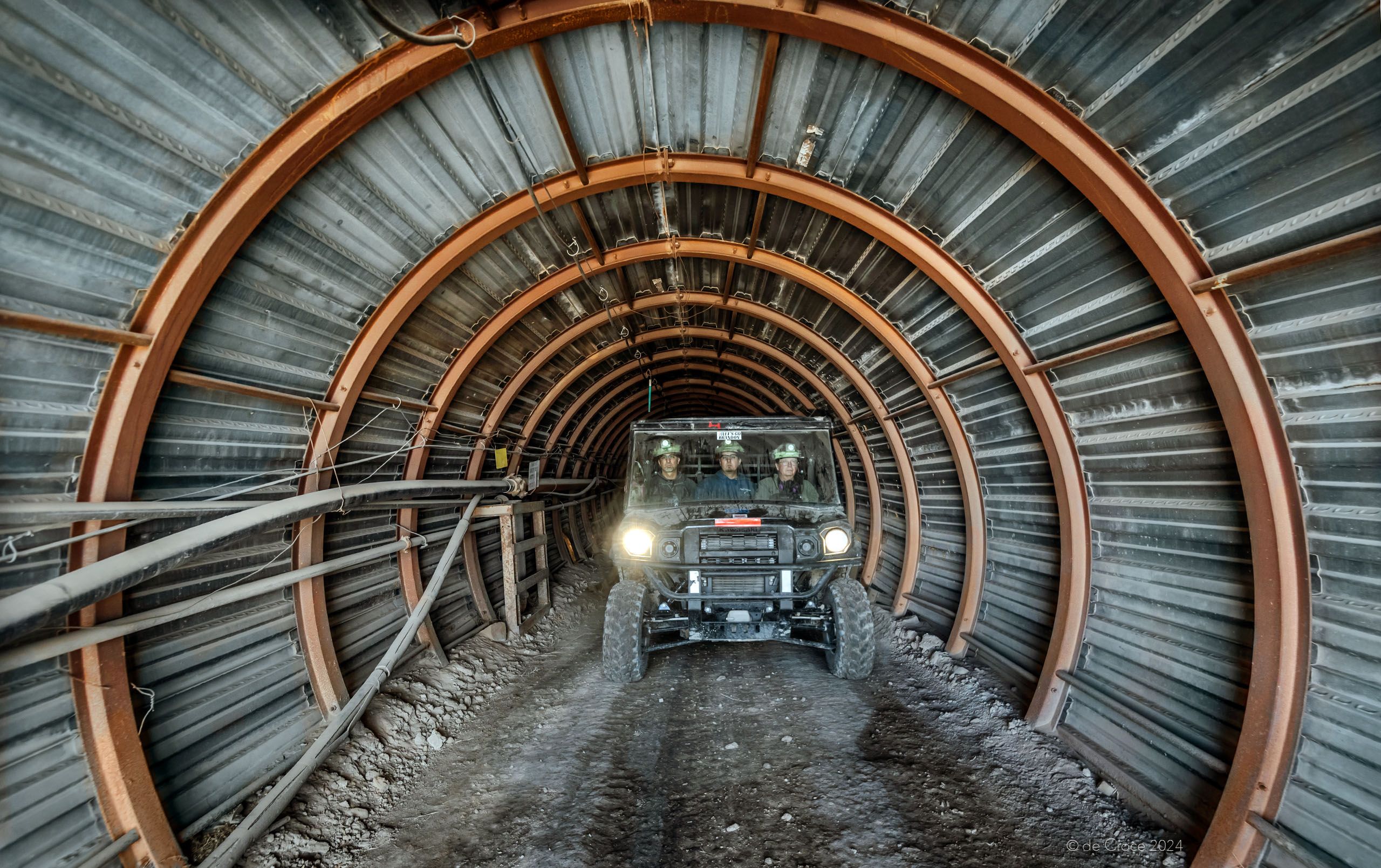 Mining Photography depicts entrance tunnel with passengers in transport vehicle shot in La Sal Uranium Mine Utah Mine Tunnel Entrance - Utah Uranium