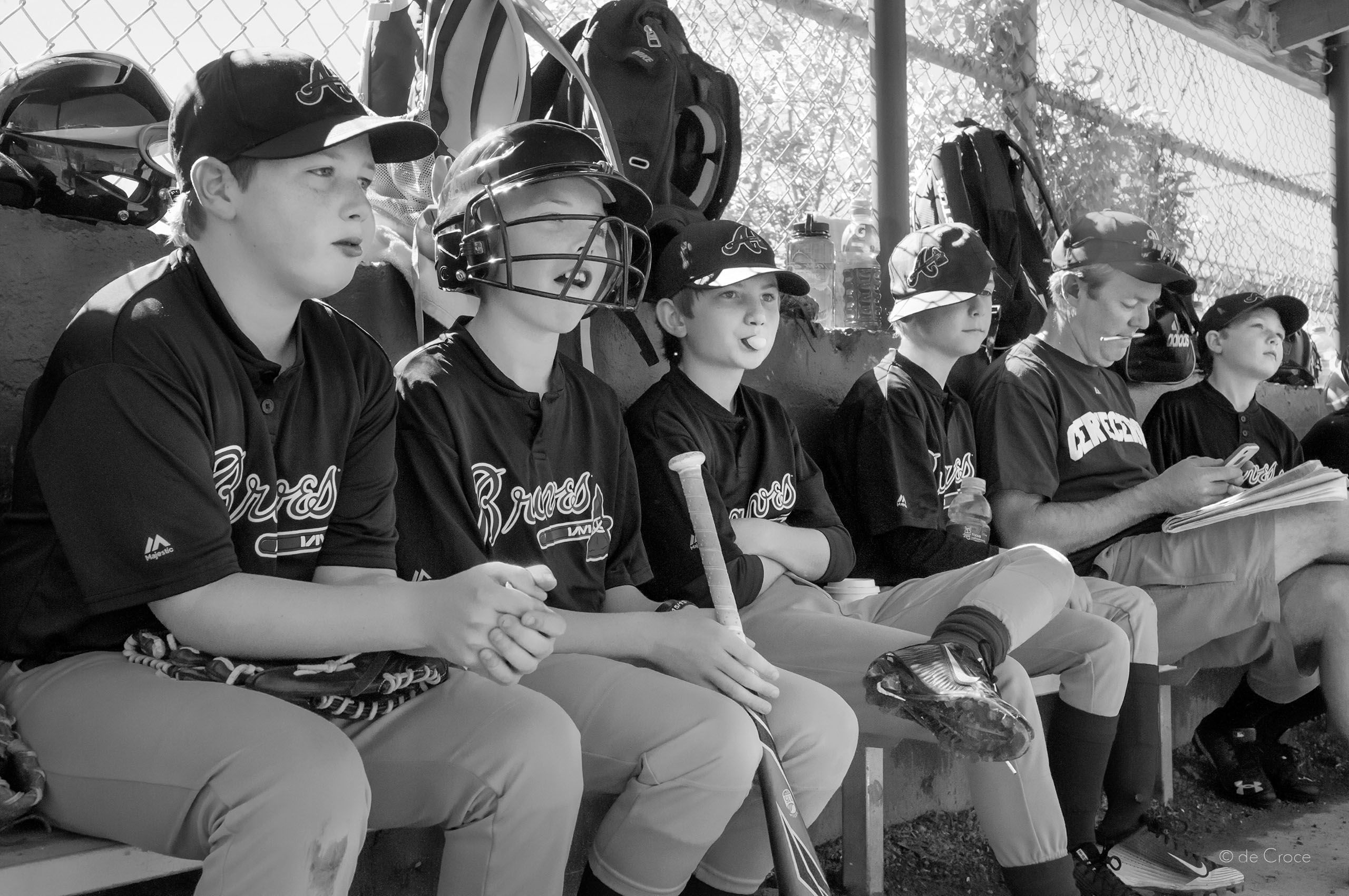 Advertising lifestyle photography illustrates  little league baseball boys in dugout with coach. The Dugout - Lifestyle Reportage Photography