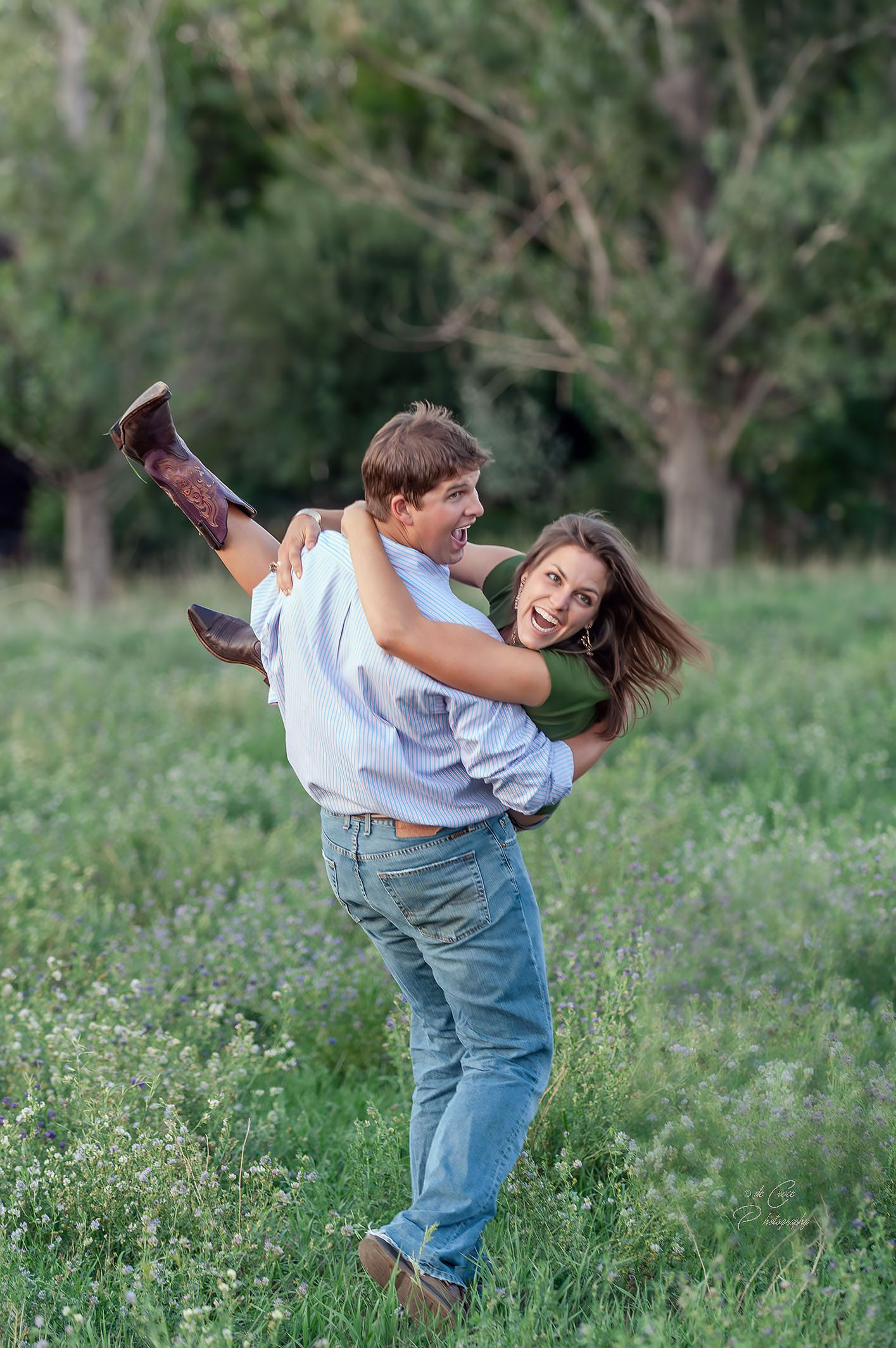 A playful young couple is depicted in this advertisement for western a boot company in Colorado. In the photograph, the man carries his lady across a field as they laugh while looking off camera to their left side. This image was selected because the wester cowboy boots are cleverly catch the eye of a viewer. Western Boot Lifestyle- Advertisement Photography