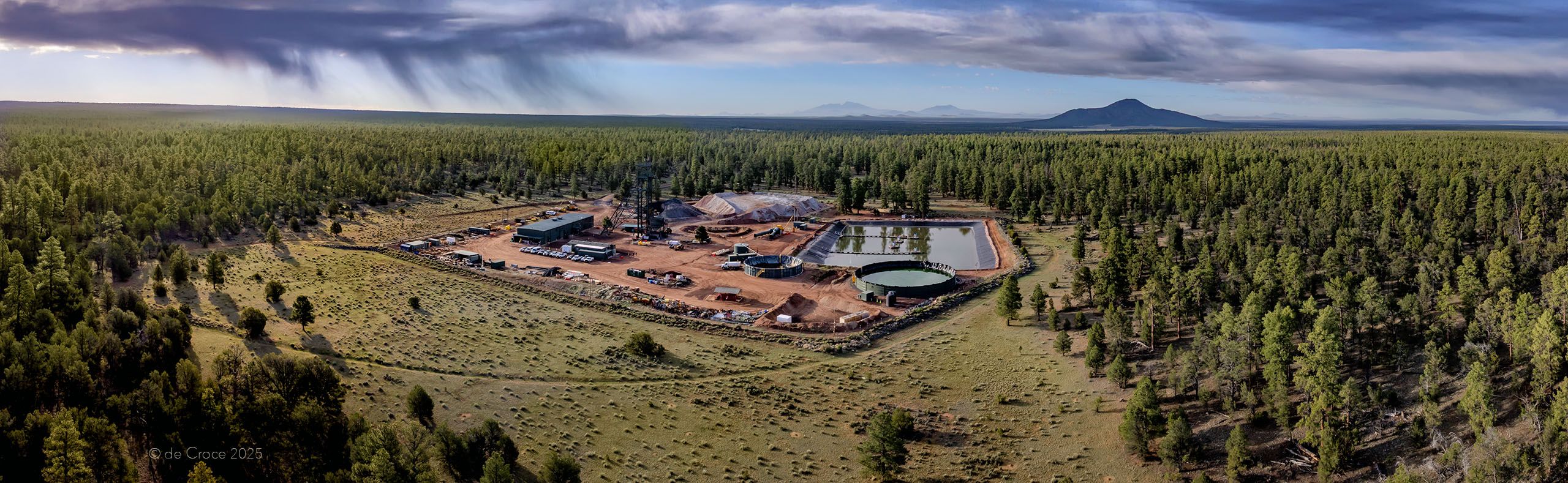 Wide aerial panorama photography captured by professional drone photographer depicts uranium mine in Arizona forest at dusk. Commercial Drone Photography Mine In Forest - Arizona