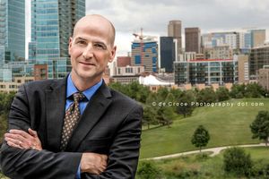Executive portrait photography with Denver skyline was done for JE Dunn Commercial Construction. Cityscape Denver Executive Photography