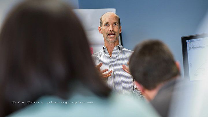 Corporate photographers in Denver from DeCroce capture motivational talk by Digital Fusion CEO Joe Morrow. Corporate Motivational Meeting