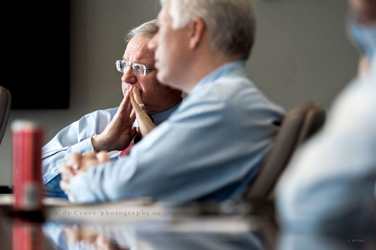 Tom Petrie and Jon Hughes of The Pertrie Partners are captured here by editorial photographers in Denver during a board room meeting at their Denver office. Editorial Photography - The Pertrie Partners