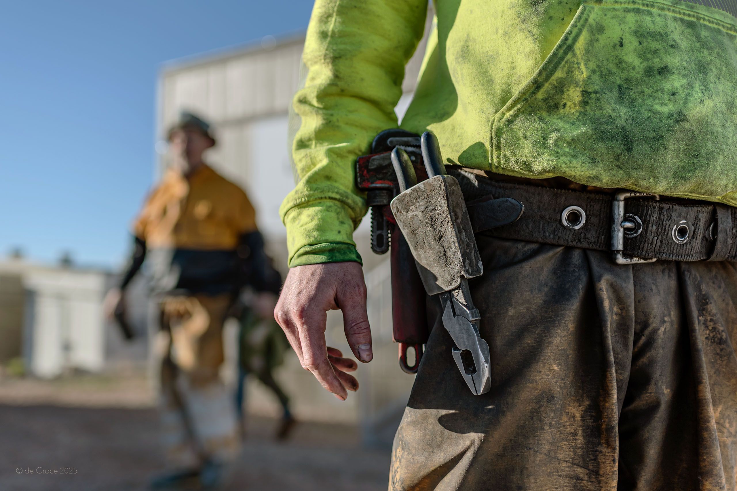 A sharp pictorial featuring a miner's belt in foreground while other's shift change out-of-focus is depicted in this industrial mining photograph Miner Belt - Utah Industrial
