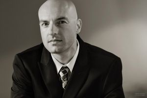 A black and white business portrait headshot accentuates contemplative mood during corporate portrait session. Contemplative Business Headshot Portrait