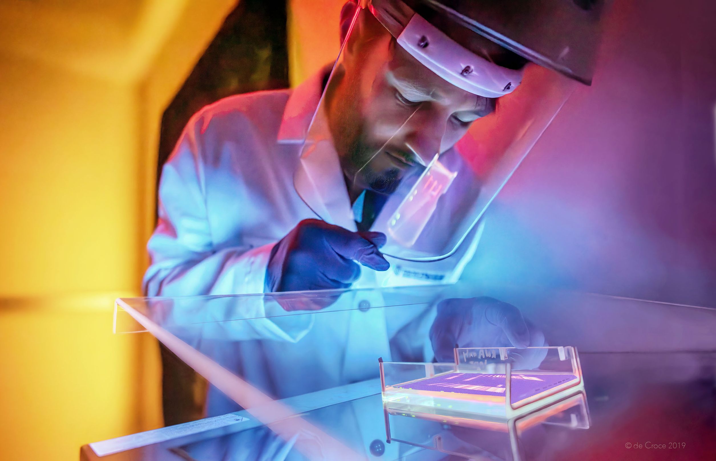 Commercial photography Denver features medical researcher working in ultraviolet environment to discover new prospects in regenerative medicine. Regenerative Medicine Commercial Photography - Medical Research - CLIENT_ Gates Institute