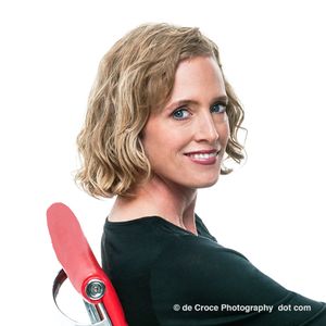 Business headshot photographers Denver composed executive profile portrait in studio with white background. The commercial headshot portrait was an advertising photography project for ICE3D. Executive Headshot Photography Red Chair On White