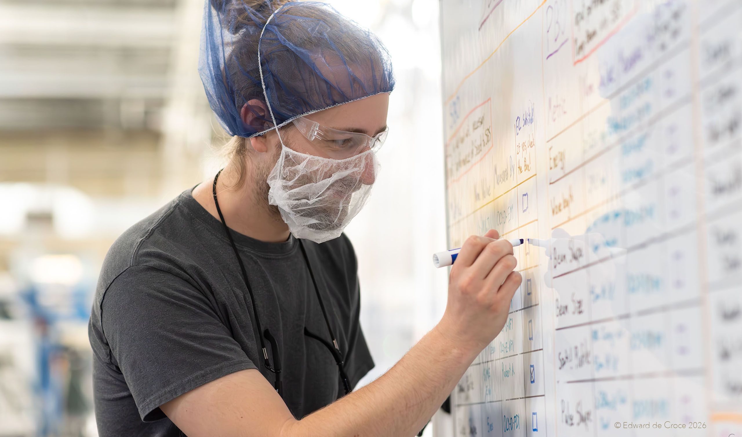 Laser scientist for nuclear fusion energy works on whiteboard at Xcimer Energy Corporation In denver, Colorado. Photographed by American industrial photographer Edward DeCroce Industrial Physicist Nuclear Fusion Laser White Board. Photographed by American industrial photographer Edward DeCroce