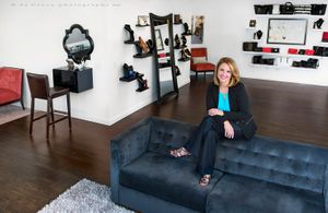 Keri Blair of the Style Studio poses on top of sofa for Denver people photographer Edward DeCroce Woman Entrepreneur Portrait Photography