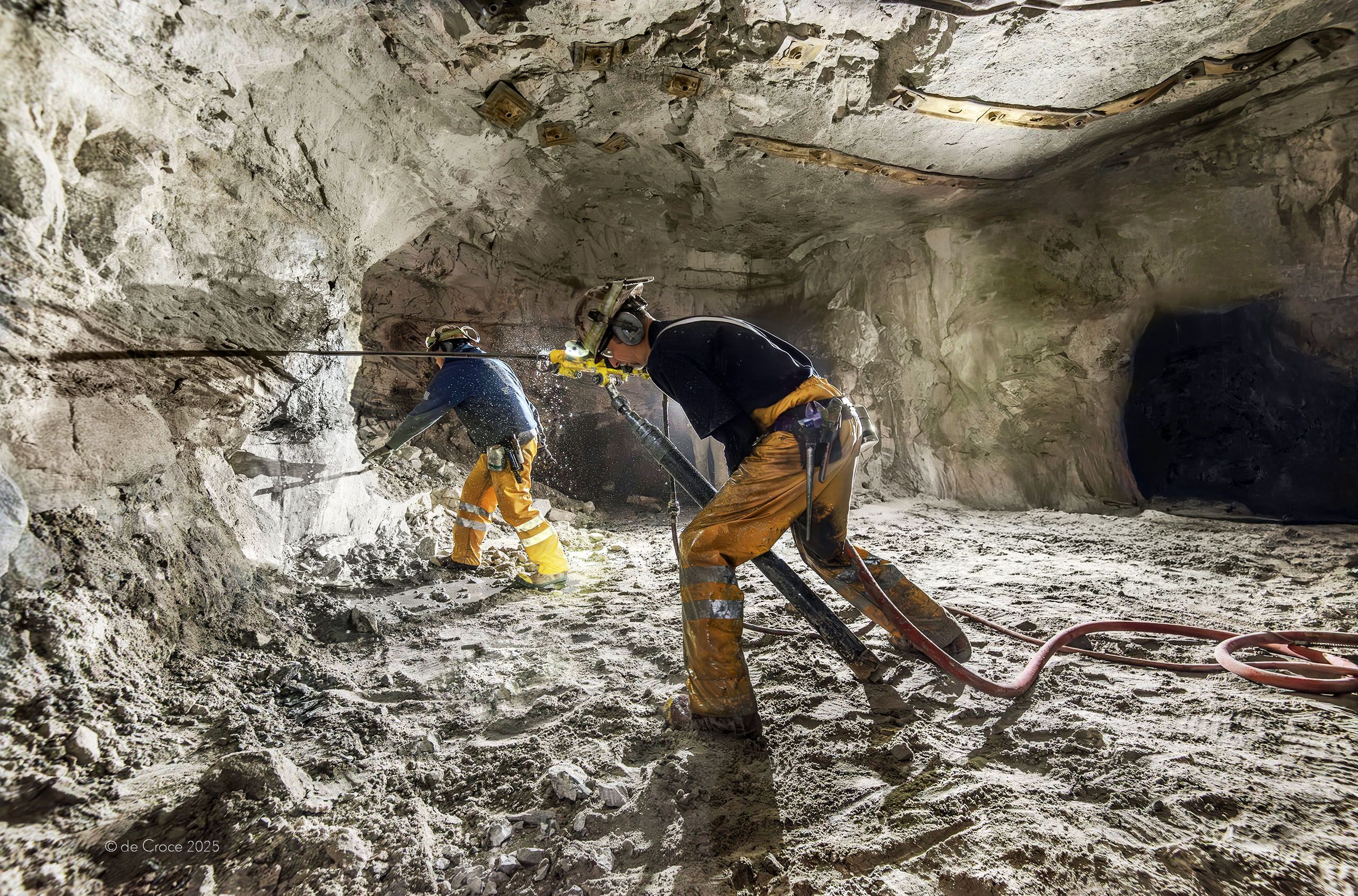 American mining photographer, DeCroce used portable strobe lights to capture backlight luminance of underground miners in action. Underground Mining Photography Strobe Backlit