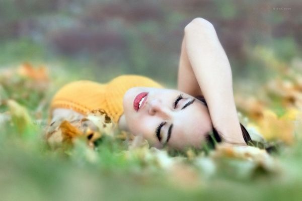 Woman in field image with closed eyes. Model Photographers Denver