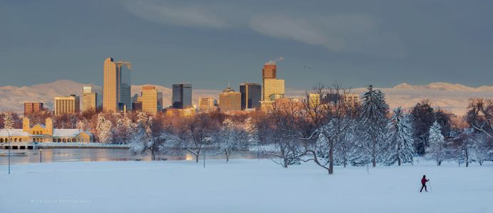 A winter scene in Denver Colorado depists city, mountains and active lifestyle skier. Denver Winter Scene