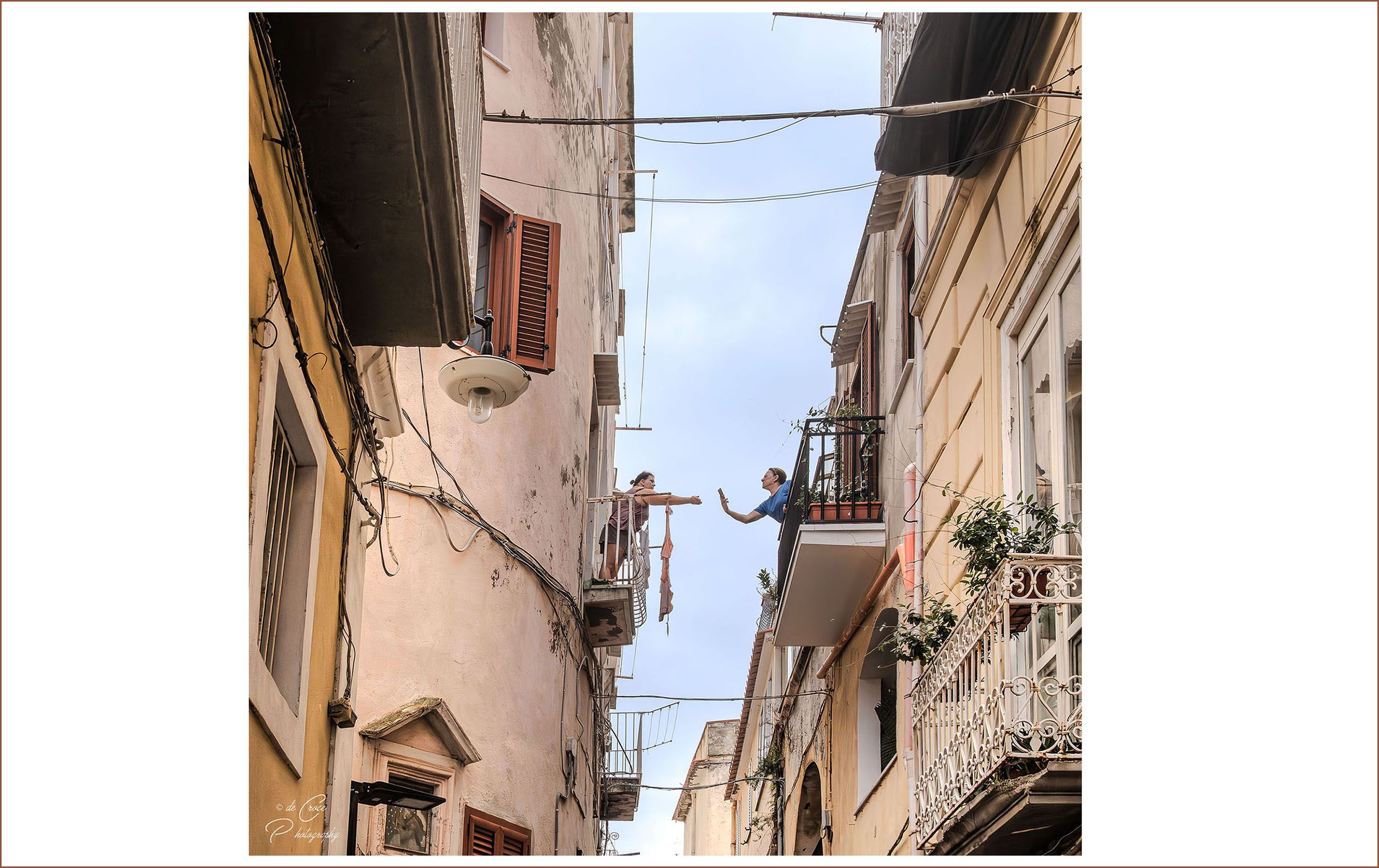 Street life in capri Italy depicts two women conversing across their balconies. Italian Neighbors Capri Island Italy
