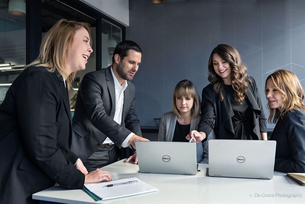 Dell advertisement photography commercial featuring office workers cajoling around Dell laptop computers. Dell Adveritesment Photography