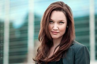 "Woman Executive Portrait" was created by the corporate photographers business in Denver as a business headshot with cityscape backgrround. Portrait in Business Photography Denver