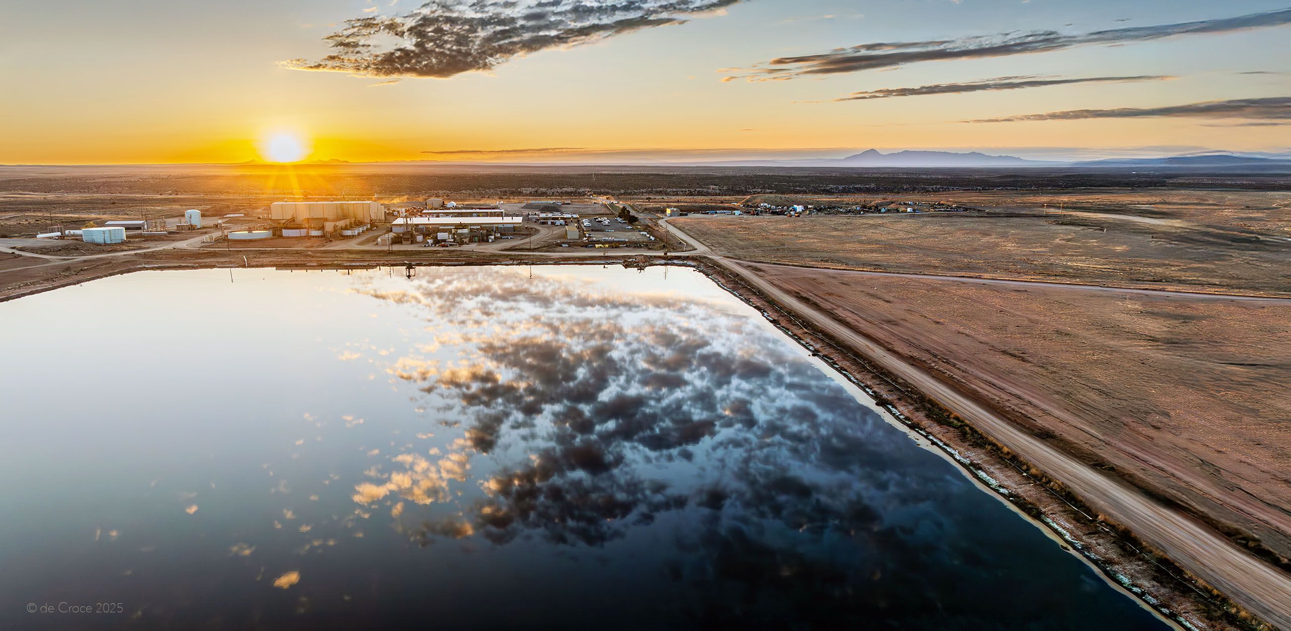 Industrial energy photography depicts aerial view of uranium processing mill near Blanding Utah operated by nergy Fuels. Sunset Reflections Over White Mesa Uranium Mill Utah - Aerial Industrial Photography