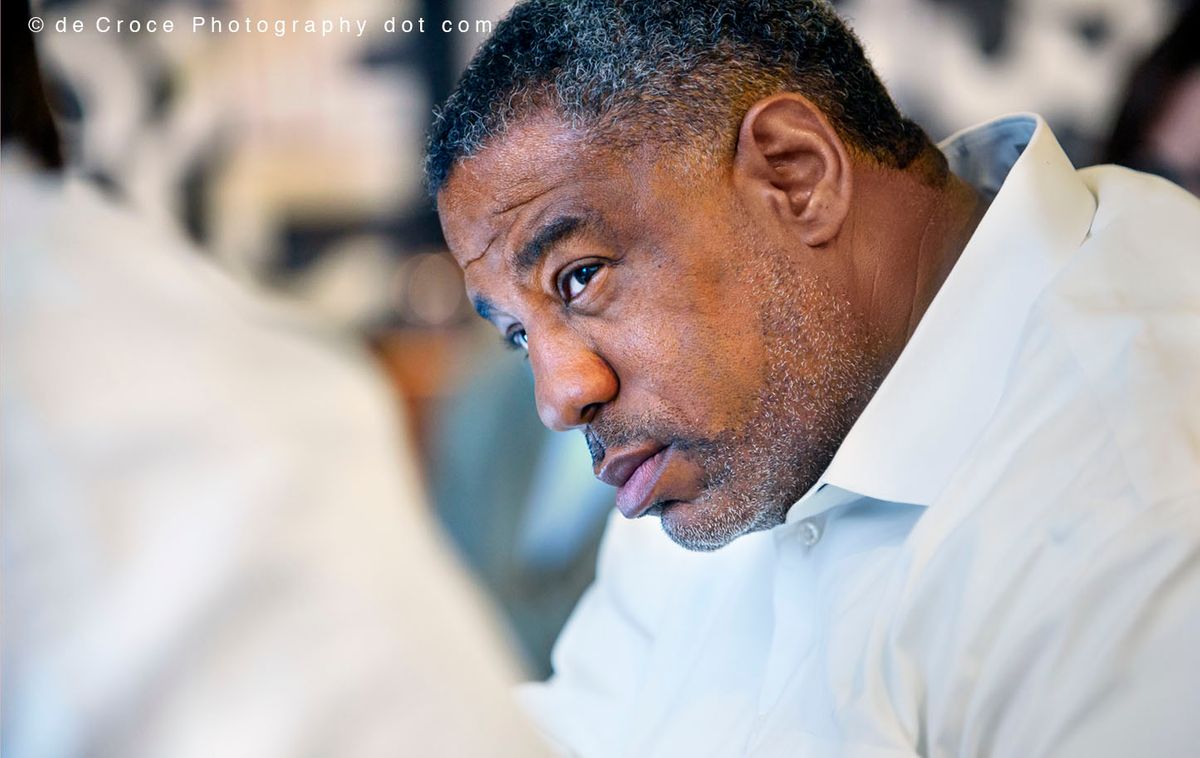 A dynamic corporate event image of African American executive in business meeting was captured by the professional photographers in Denver from DeCroce Denver tech business photography jpg