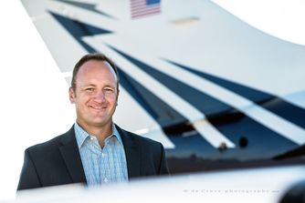 Marty Moser, CEO of Moser aviation poses for Denver corporate photographer in this business portrait head-shot near Denver at Centennial Airport. Pilot Portrait Photography Corporate - Marty Moser