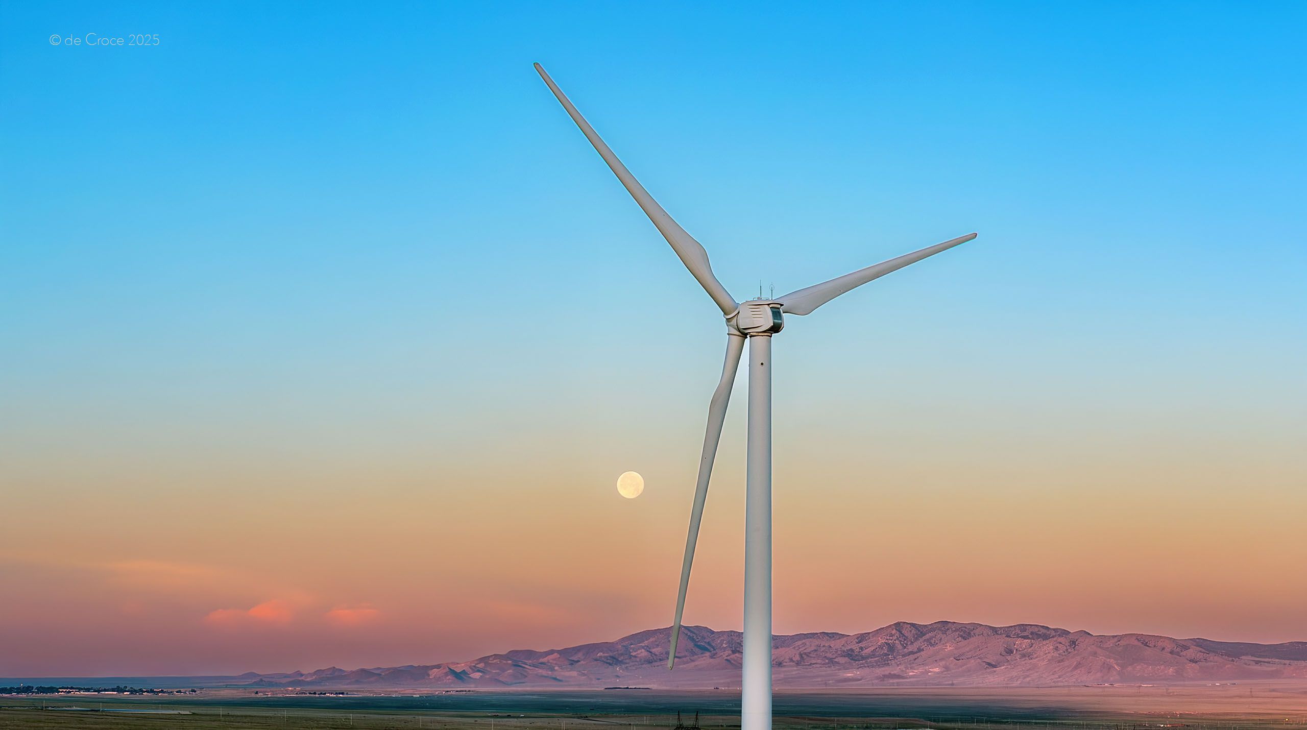 Wind turbine at dusk light under wildfire smoke skies in Utah is displayed in the commercial photography. Commercial Drone Photography - Wind Turbine Wild Fire Smoke Sky - Utah