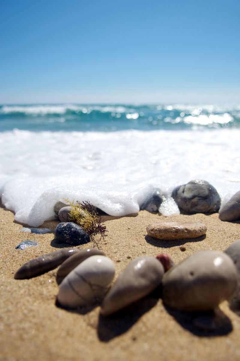 Pebbles washed by sea foam