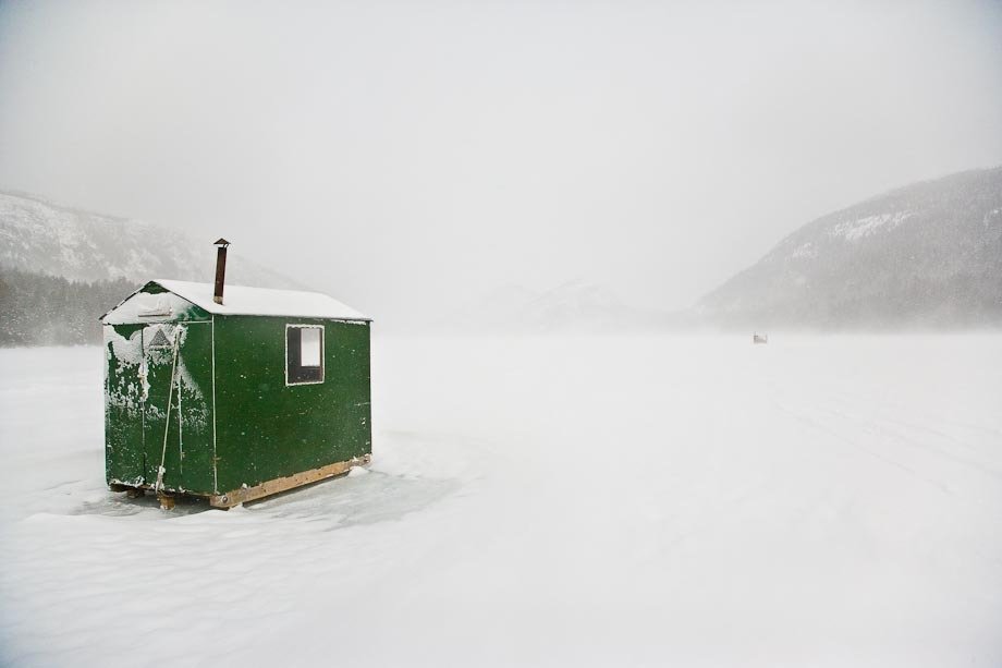Ice fishing shacks on Jordan Pond in Acadia National Park, during a winter storm.
