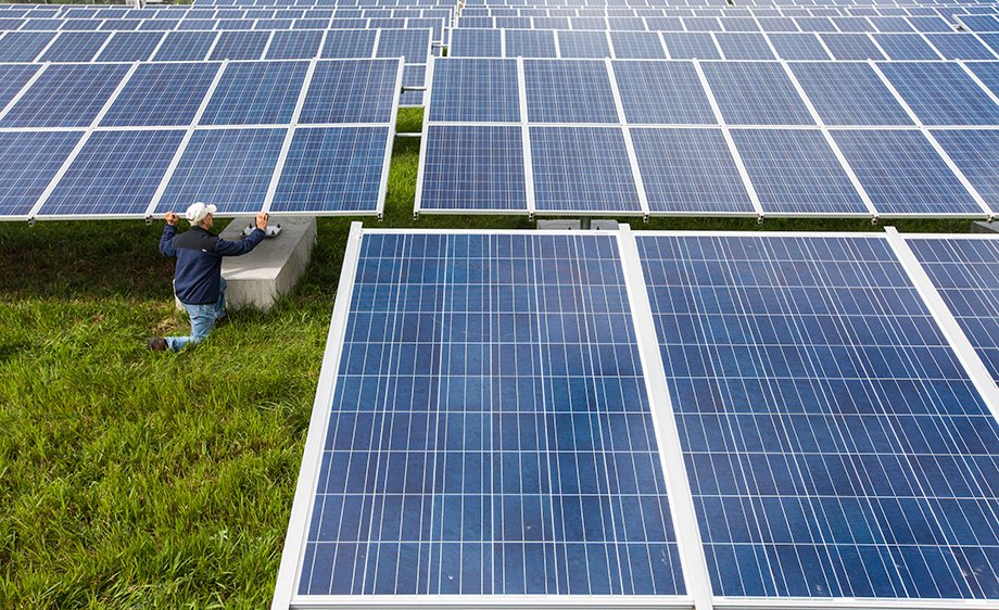 A technician inspecting solar panels.