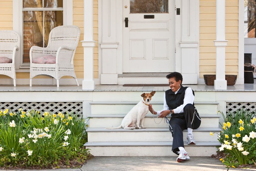 African American woman, at home with her dog.