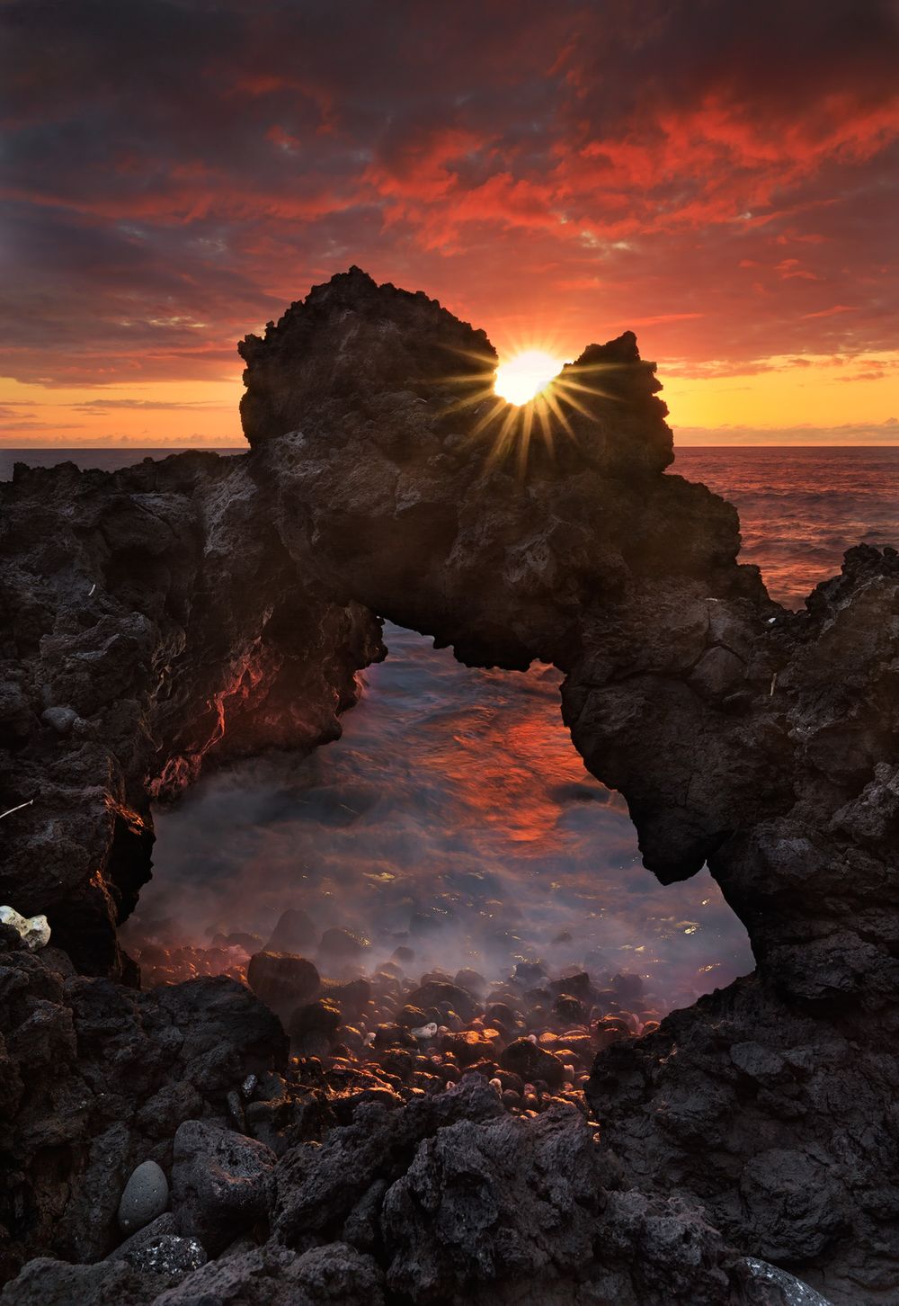 Lava Rock Arch Under Burning Sky