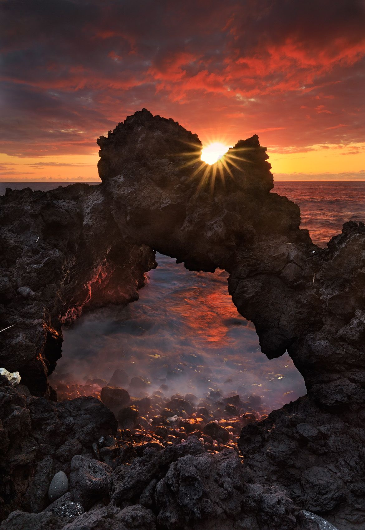 Lava Rock Arch Under Burning Sky