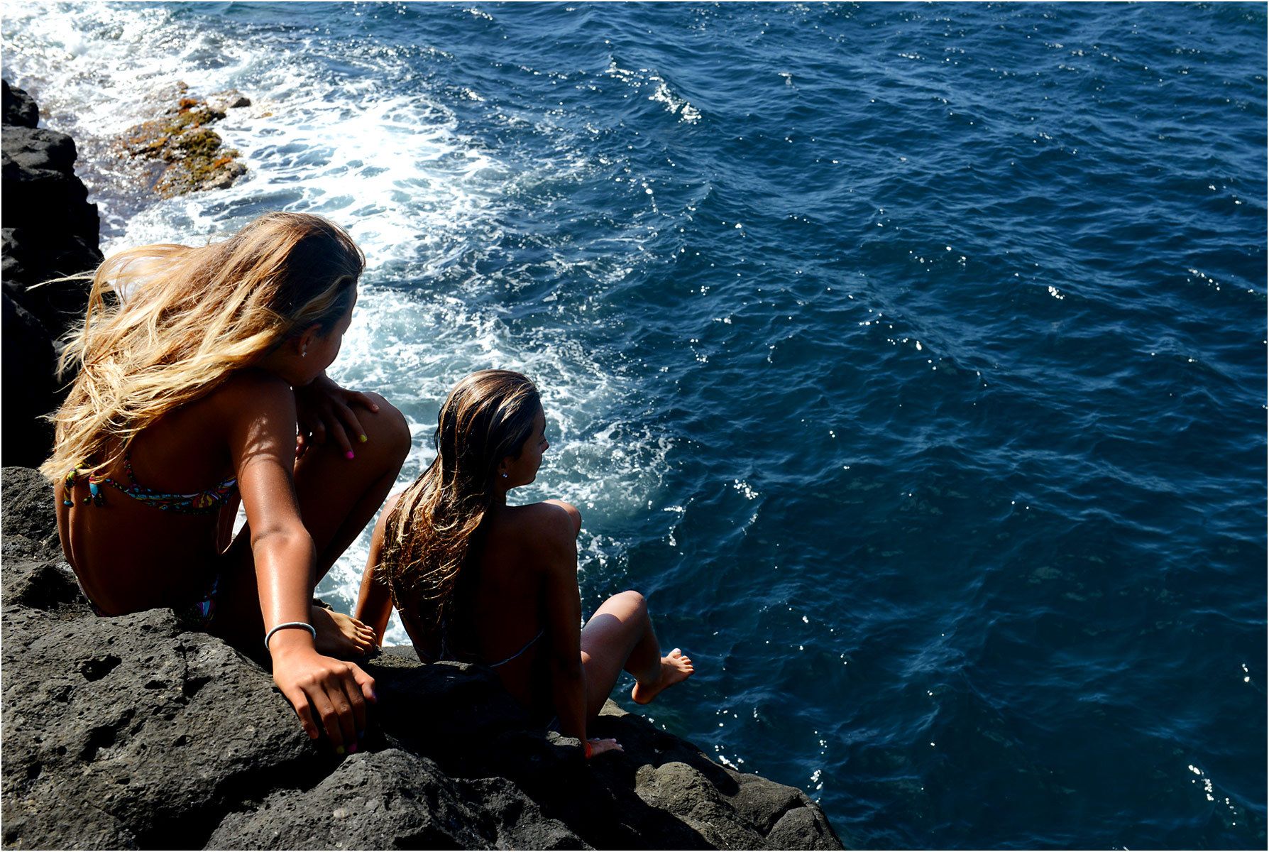 1two_girls_sitting_on_cliff.jpg