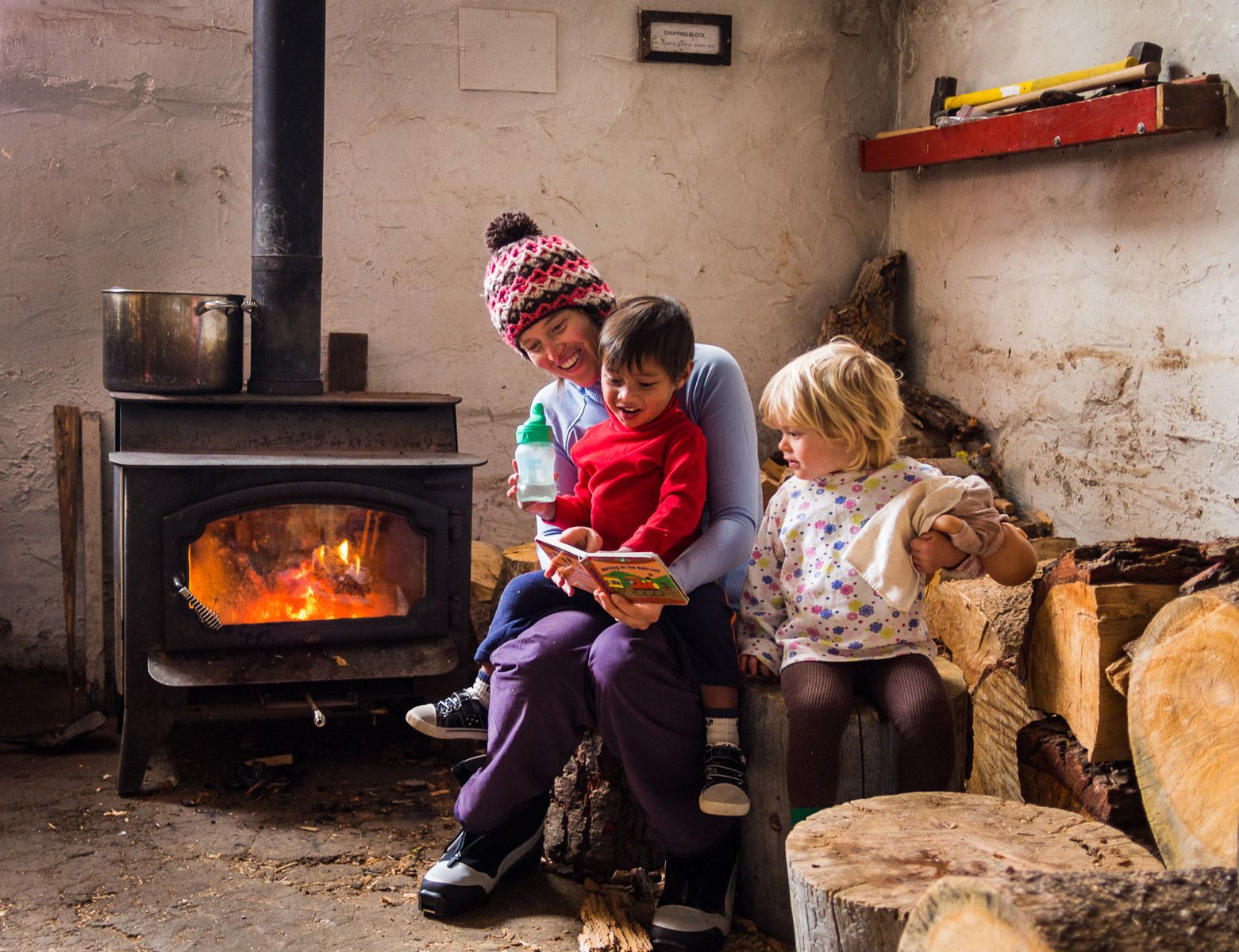 Mom Reading to Kids by Fireplace