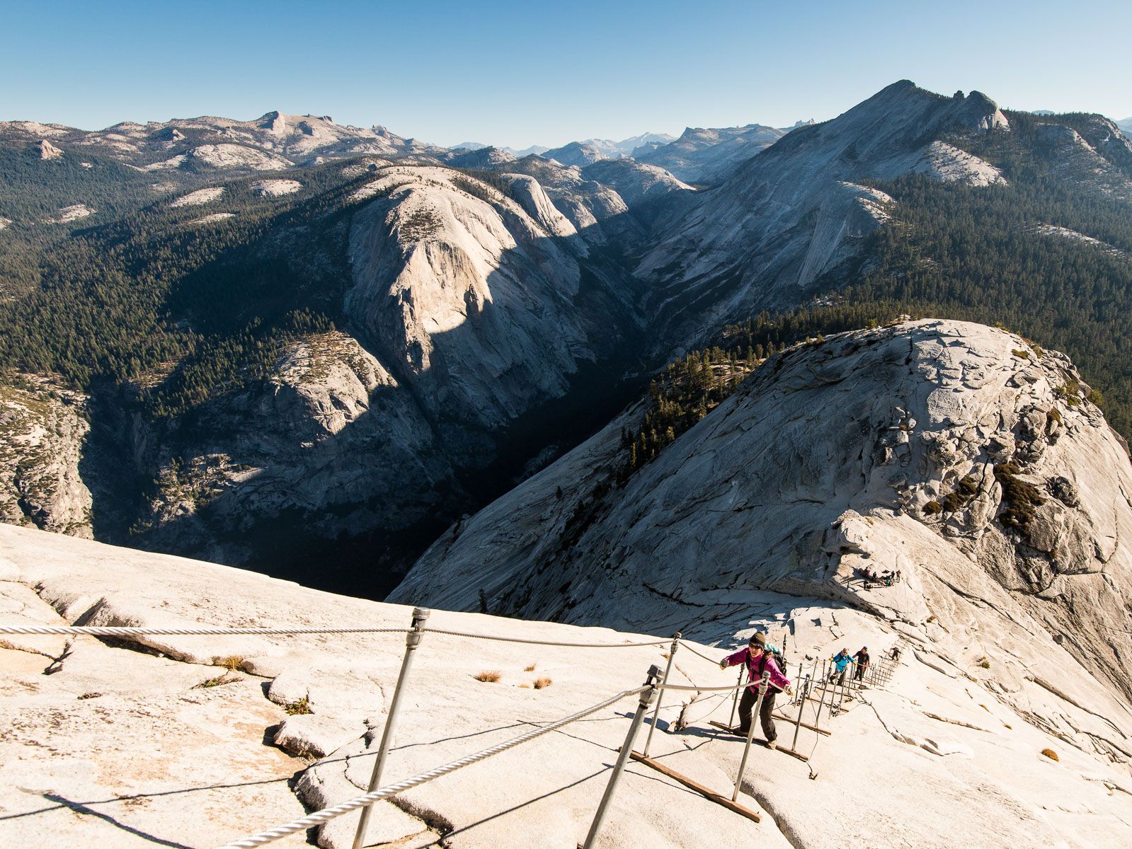 Woman climbs the Half Dome Cables