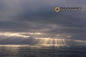 Rays emit from the clouds over the Pacific Ocean near Sant Cruz, California, USA Pacific Rays