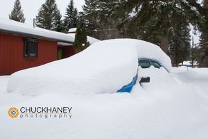 Parked car buried under deep snowfall in Whitefish Montana Jacks Car