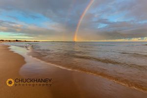 Full arcing rainbow over Lake Michigan and Ludington lighthouse in Ludington, Michigan, USA Ludington
