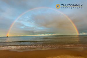 Full arcing rainbow over Lake Michigan and Ludington lighthouse in Ludington, Michigan, USA Ludington