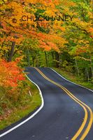 Colorful maple trees in autumn line scenic Highway 41 as it leads into Copper Harbor Michigan Highway 41