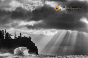 Waves crash below Lighthouse at Cape Disappointment State Park, Washington, USA