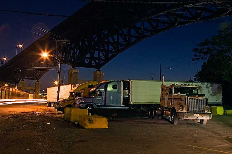 Long haul tractor traliers parked at the Skyway Diner under the Pulaski Skyway in Kearny NJ. Trucks in Diner Light, 2005