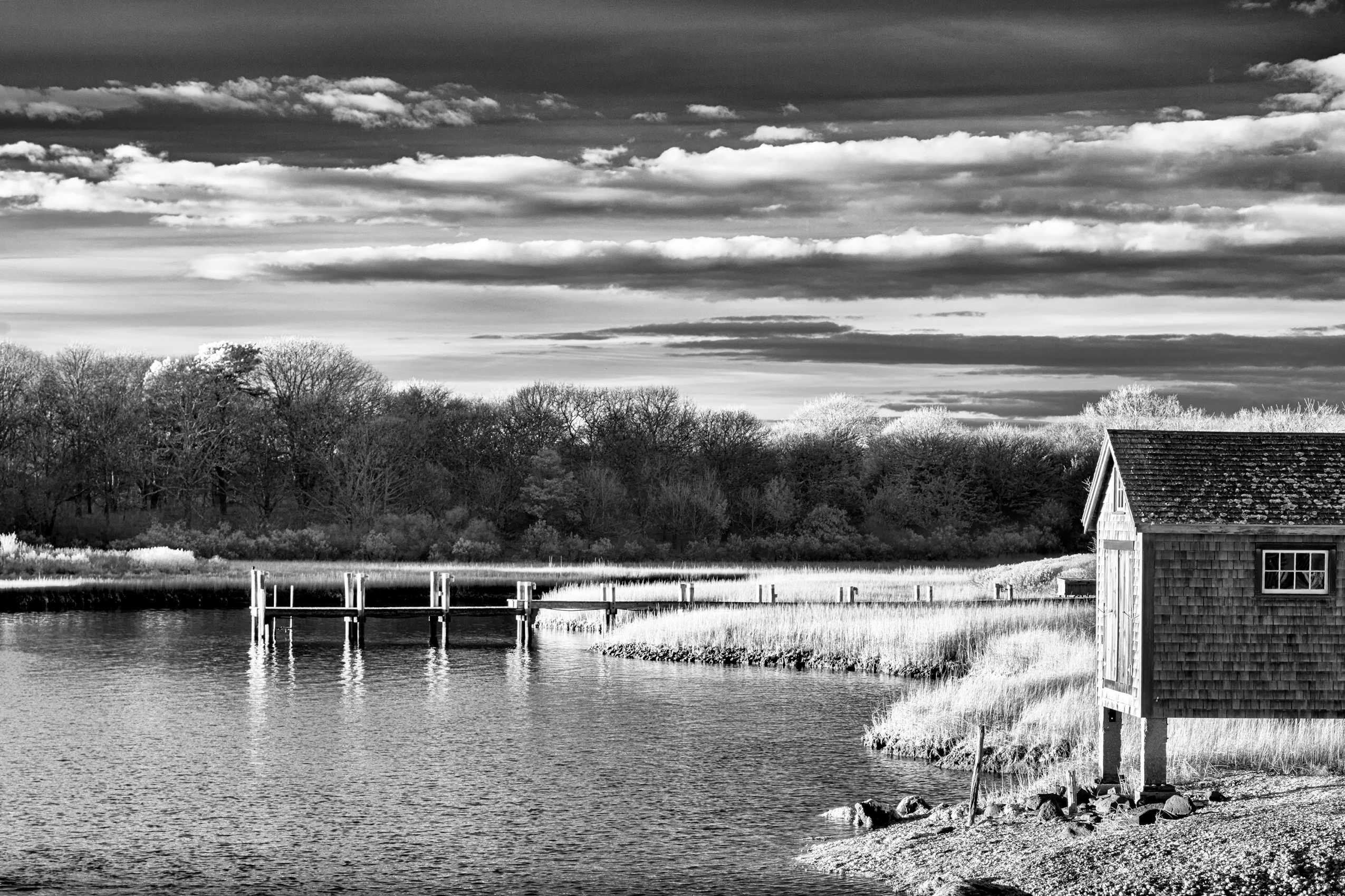 24x16" Archival Pigment Print. Infrared photograph of a boat house on Quitsa Pond in late day Winter light. December 2024 Boat House - Quitsa Pond, Chilmark, Martha's Vineyard, MA