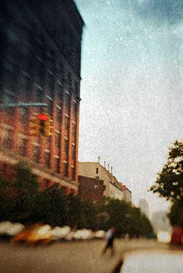 A pedestrian dashes across Christopher Street in Greenwich Village. Gathering Summer Storm, New York City 2008