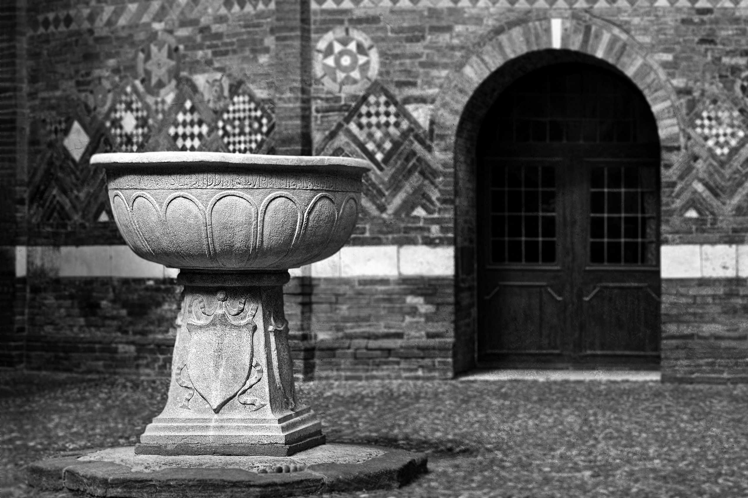 An 8th Century Lombard stone basin resting on a 16th Century pedestal in the 11th Century Pilate's Courtyard. Pilate's Basin