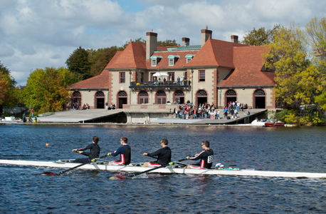 Head of the Charles rowing crew passing Harvard Boat House