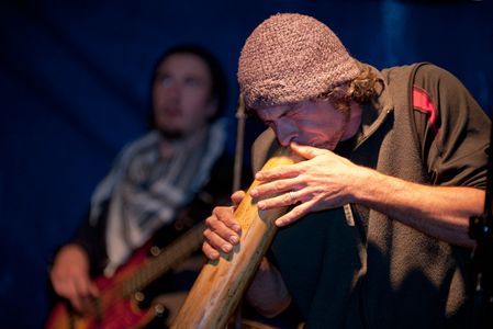 musician playing digereedoo at local outdoor concert